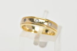 AN 18CT GOLD DIAMOND BAND RING, a yellow gold band with two diamond cut lines to the edges, flush
