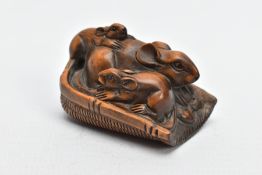 A CHINESE WOODEN NETSUKE, a small carved wooden netsuke depicting three mice in a basket, signed