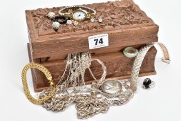 A CARVED WOODEN BOX WITH CONTENTS, to include a silver articulated bracelet fitted with a lobster