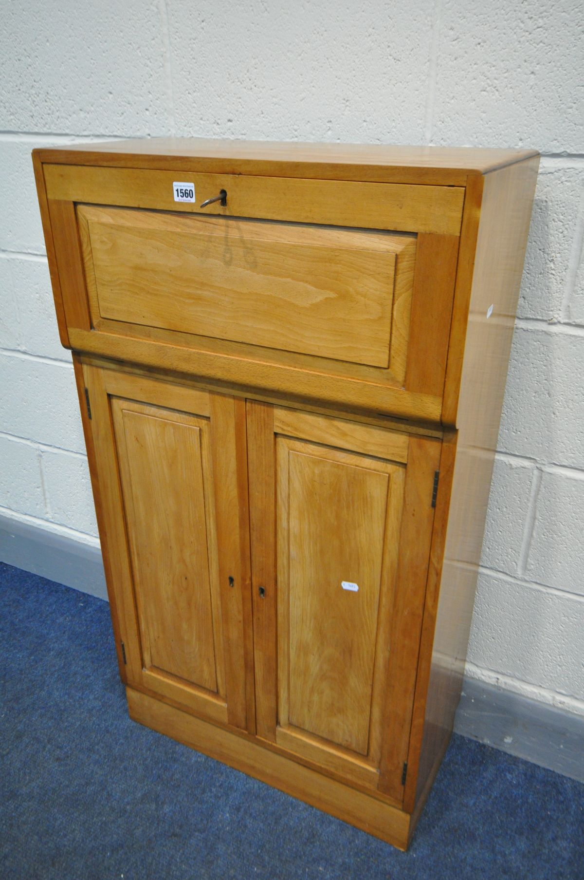 A SLIM BIRCH BUREAU, the fall front with a fitted interior, above a base with double fielded panel