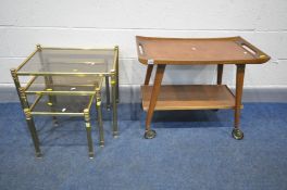 A MID CENTURY TEAK TEA TROLLEY, along with a brassed nest of three tables with smoked glass inserts,