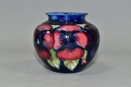 A SMALL MOORCROFT POTTERY BALUSTER VASE, decorated with tubelined pink and purple Pansy pattern on a