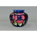 A SMALL MOORCROFT POTTERY BALUSTER VASE, decorated with tubelined pink and purple Pansy pattern on a