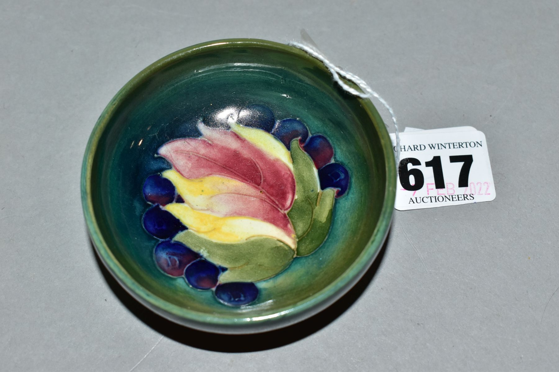 A MOORCROFT LEAF AND BERRY PATTERN FOOTED BOWL, impressed marks to the base, approximate diameter