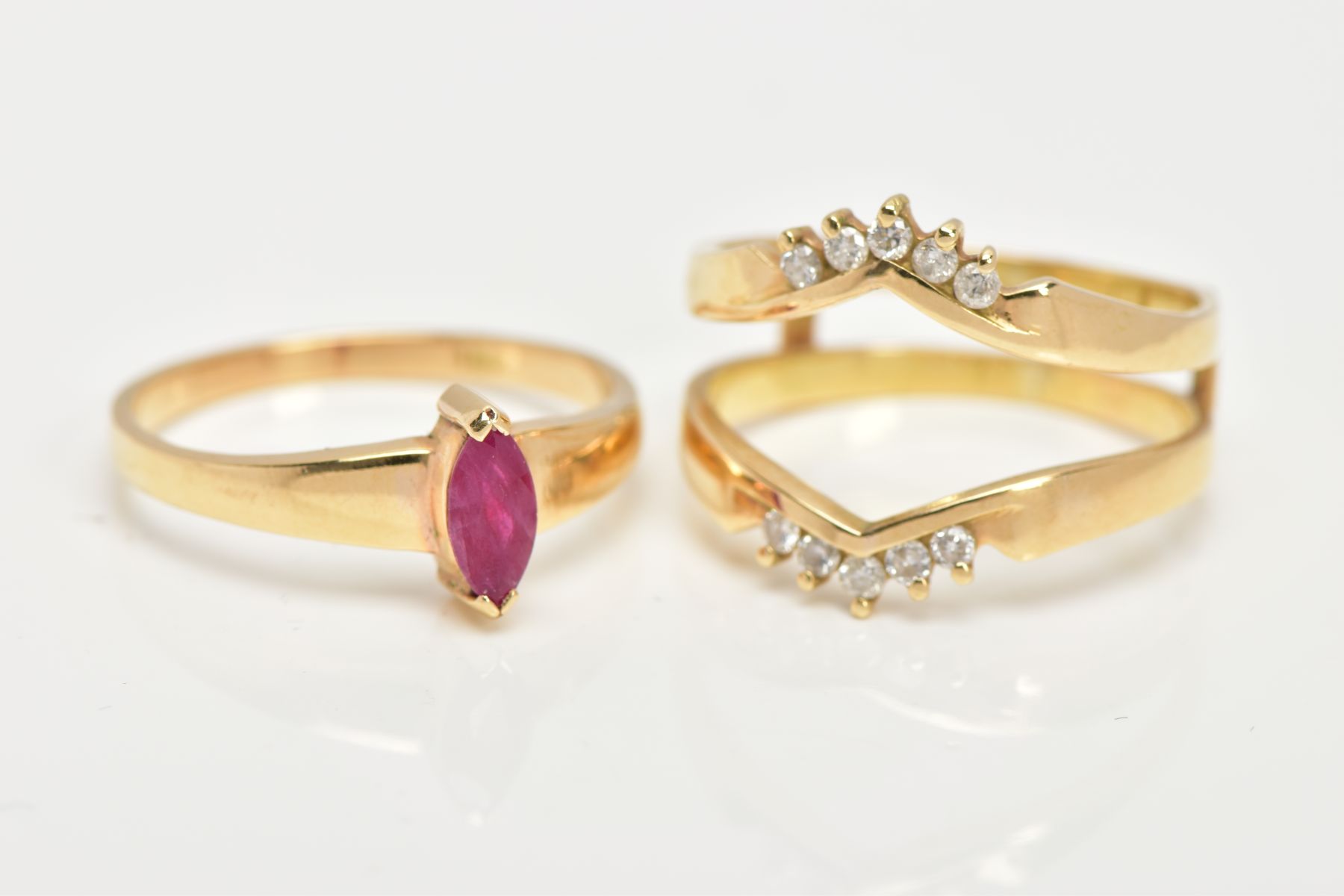 A YELLOW METAL RUBY AND DIAMOND PUZZLE RING, the centre ring designed with a tension set, marquise - Image 5 of 6