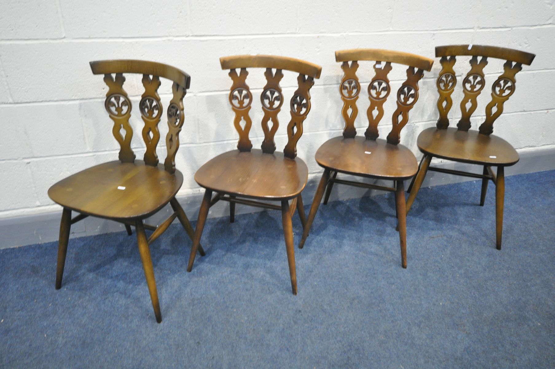 A SET OF FOUR ERCOL PRINCE OF WALES FEATHER BACK CHAIRS