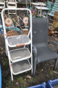 TWO WROUGHT IRON TILE BACK FOLDING GARDEN CHAIRS, along with two stacking garden armchairs and a