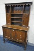 AN OAK DRESSER with various cupboard doors, width 122cm x depth 51cm x height 195cm and an oak