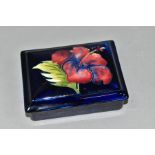 A MOORCROFT POTTERY HIBISCUS TRINKET BOX rectangular trinket box and cover decorated with red/blue
