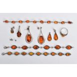A SELECTION OF AMBER SET JEWELLERY, to include two white metal bracelets set with amber cabochons,