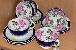 A SET OF SIX AYNSLEY ROSE PATTERN TEACUPS, the cups have a cobalt blue glaze to the exterior with