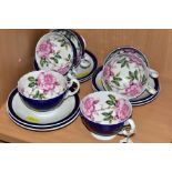 A SET OF SIX AYNSLEY ROSE PATTERN TEACUPS, the cups have a cobalt blue glaze to the exterior with