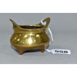 A CHINESE BRASS THREE-FOOTED CENSER, with two handles, three tapering feet and character marks to