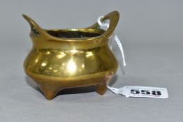 A CHINESE BRASS THREE-FOOTED CENSER, with two handles, three tapering feet and character marks to