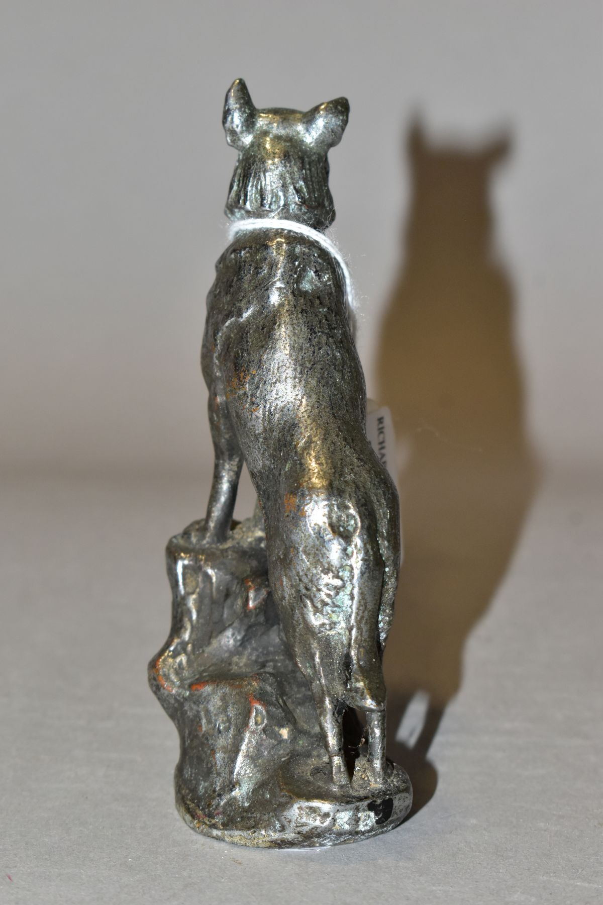 A CHROMED METAL CAR MASCOT IN THE FORM OF AN ALSATIAN STANDING WITH ITS FRONT LEGS ON A ROCK, - Image 4 of 6
