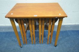 IN THE MANNER OF POUL HUNDEVAD, a mid-century teak nesting tables, with four circular drop leaf