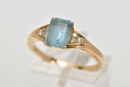 A YELLOW METAL GEM SET RING, designed with a central rectangular cut aquamarine in a four claw