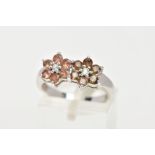 A 9CT WHITE GOLD GEM SET CLUSTER RING, a double flower design set with twelve circular cut stones