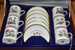 A BOXED ROYAL WORCESTER SET OF SIX COFFEE CANS AND SAUCERS PRINTED WITH BOTANICAL STUDIES, gilt