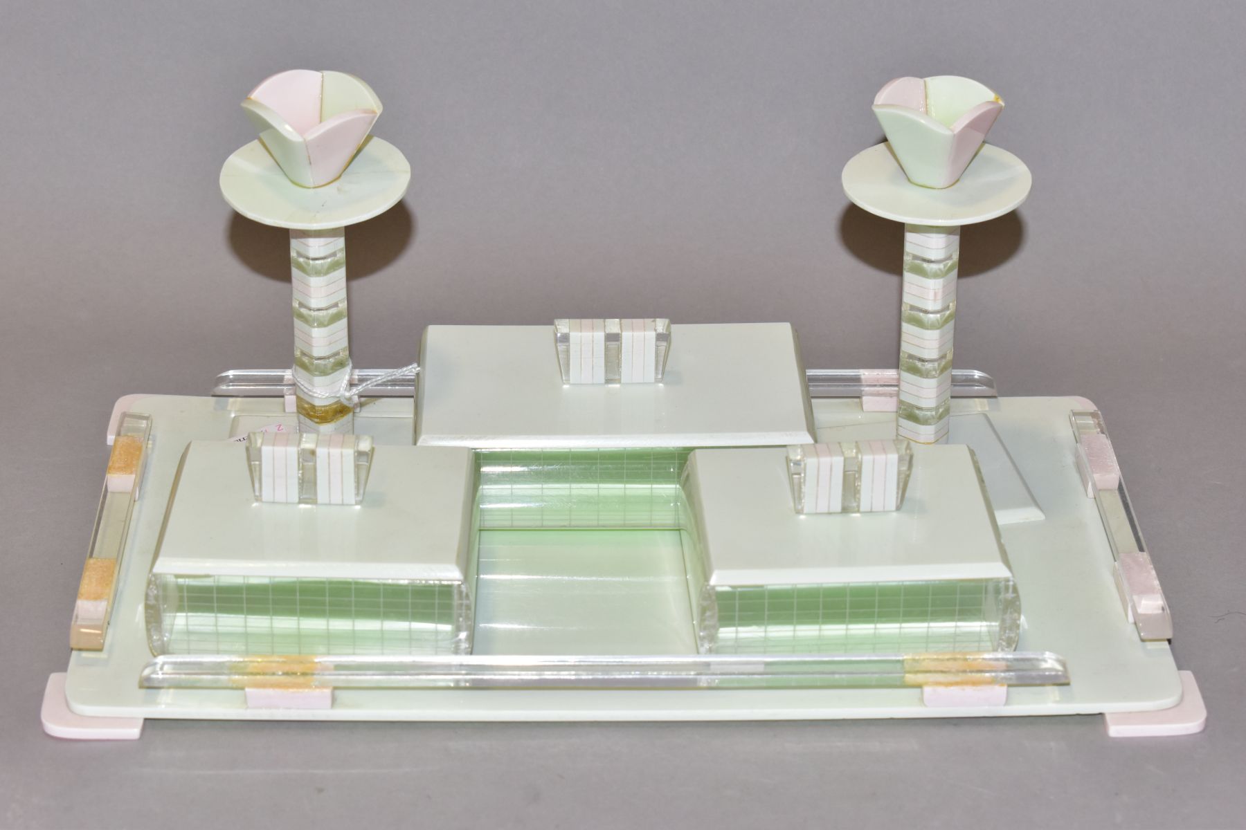 AN ART DECO PINK, GREEN AND CLEAR PLASTIC DRESSING TABLE SET, comprising rectangular tray, a pair of