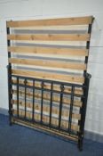 A HEAVY WROUGHT IRON 4FT6 BEDSTEAD, with pine slats