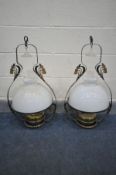 A PAIR OF WROUGHT IRON HANGING LANTERNS, with a white glass shade, brass reservoir and funnel,