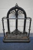 A CAST IRON UMBRELLA STAND, with two divisions, foliate decoration, and two removable trays, width