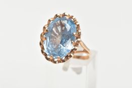 A TOPAZ DRESS RING, a large oval cut blue stone assessed as topaz, approximate length 17mm,