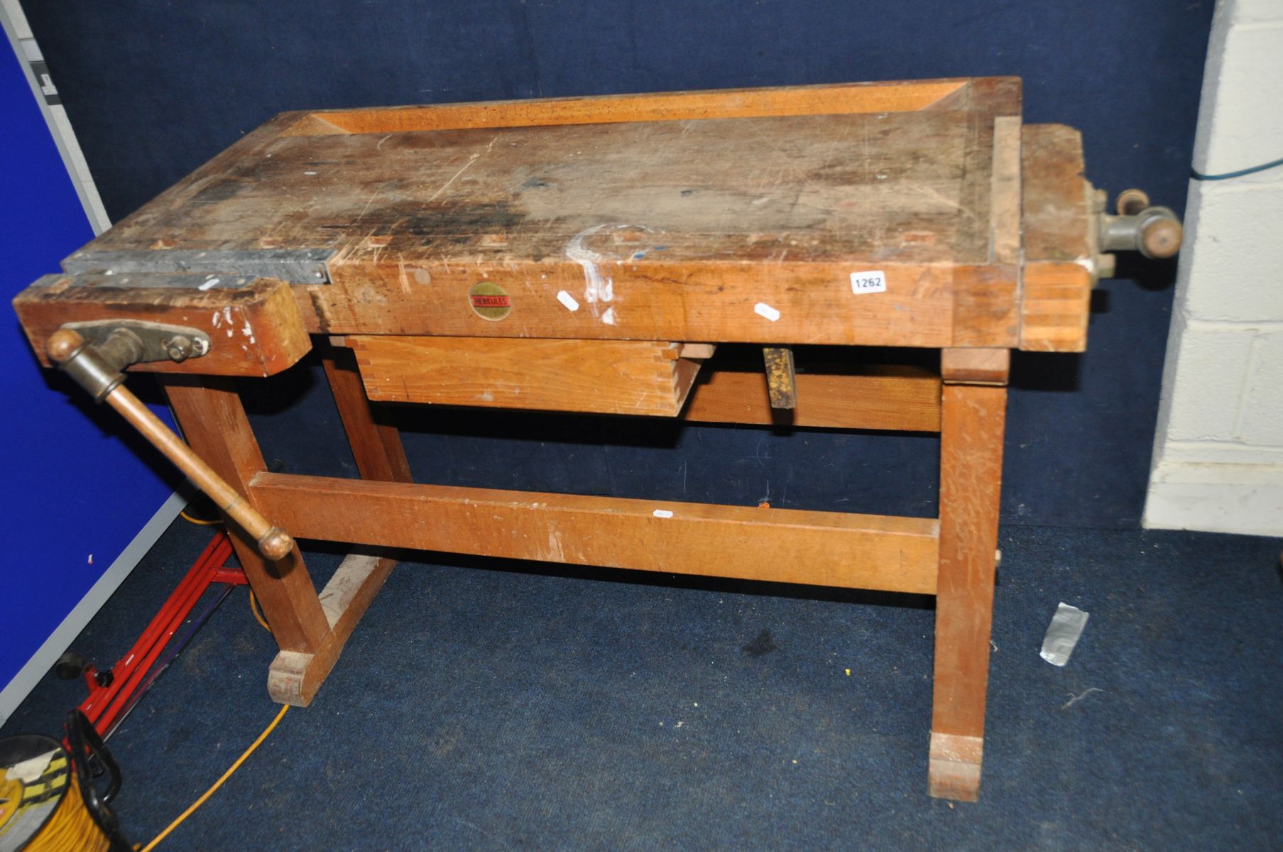 A HERKULES CARPENTER WORKBENCH with a vice on one end and one to the front, single central drawer,