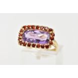 AN AMETHYST AND GARNET DRESS RING, a fancy cut amethyst set with a halo of circular cut garnet