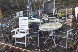 A ROUND GLASS TOPPED METAL GARDEN TABLE 80cm in diameter with four similar folding chairs, a white