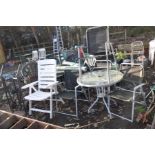 A ROUND GLASS TOPPED METAL GARDEN TABLE 80cm in diameter with four similar folding chairs, a white