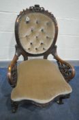 A VICTORIAN ROSEWOOD SPOON BACK ARMCHAIR, with an oval buttoned back, acanthus decoration