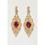 A PAIR OF GARNET EARRINGS, a pair of yellow metal filigree designed drop earrings, set with an