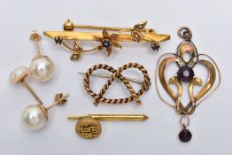 AN ASSORTMENT OF YELLOW METAL ITEMS, to include a yellow metal knotted rope brooch, a floral