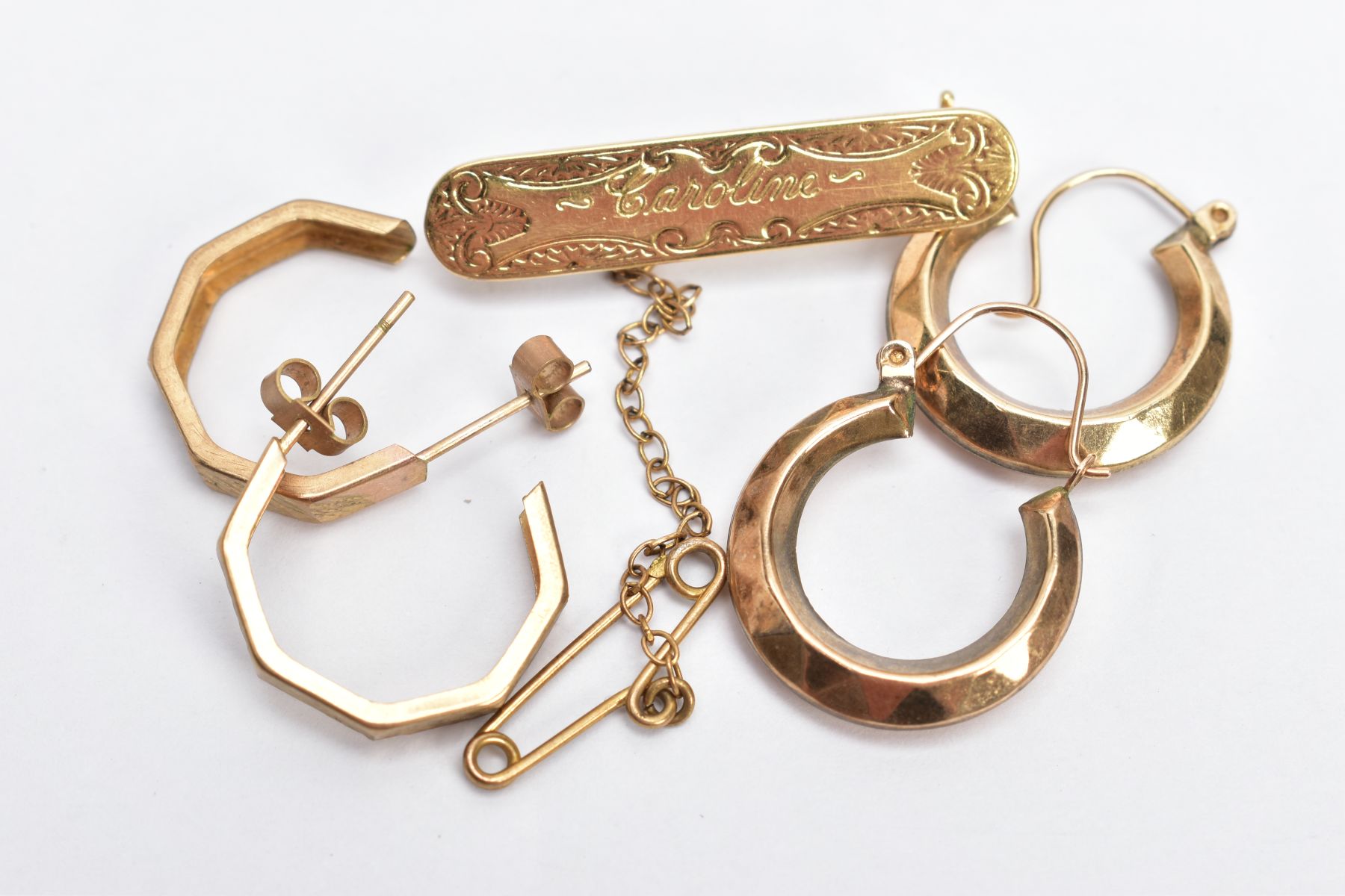 A YELLOW METAL SWEETHEART BROOCH AND TWO PAIRS OF HOOP EARRINGS, the brooch of a rounded rectangular