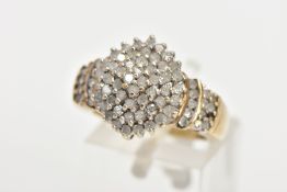 A DIAMOND CLUSTER RING,a yellow metal diamond cluster ring, tapered shoulders to a plain polished