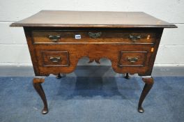 A GEORGE III OAK AND MAHOGANY CROSSBANDED LOWBOY, with three drawers, wavy apron, on Queen Anne legs