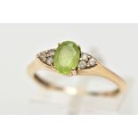 A 9CT GOLD PERIDOT RING, an oval cut peridot, accented with six circular cut cubic zirconia, in a
