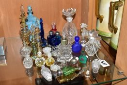 A COLLECTION OF 19TH AND 20TH CENTURY PERFUME BOTTLES , SPARE STOPPERS AND A FUNNEL, mostly glass,