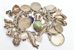 A WHITE METAL CHARM BRACELET, WITH SILVER AND WHITE METAL CHARMS, a curb link chain fitted with a
