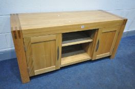 A SOLID LIGHT OAK TV STAND, with two cupboard door flanking and open section, width 136cm x depth