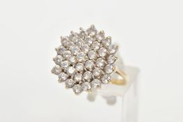 A 9CT GOLD CUBIC ZIRCONIA CLUSTER RING, thirty seven circular cut cubic zirconia within a yellow