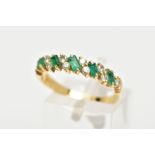 AN 18CT GOLD EMERALD AND DIAMOND HALF ETERNITY RING, designed with a row of rectangular cut emeralds