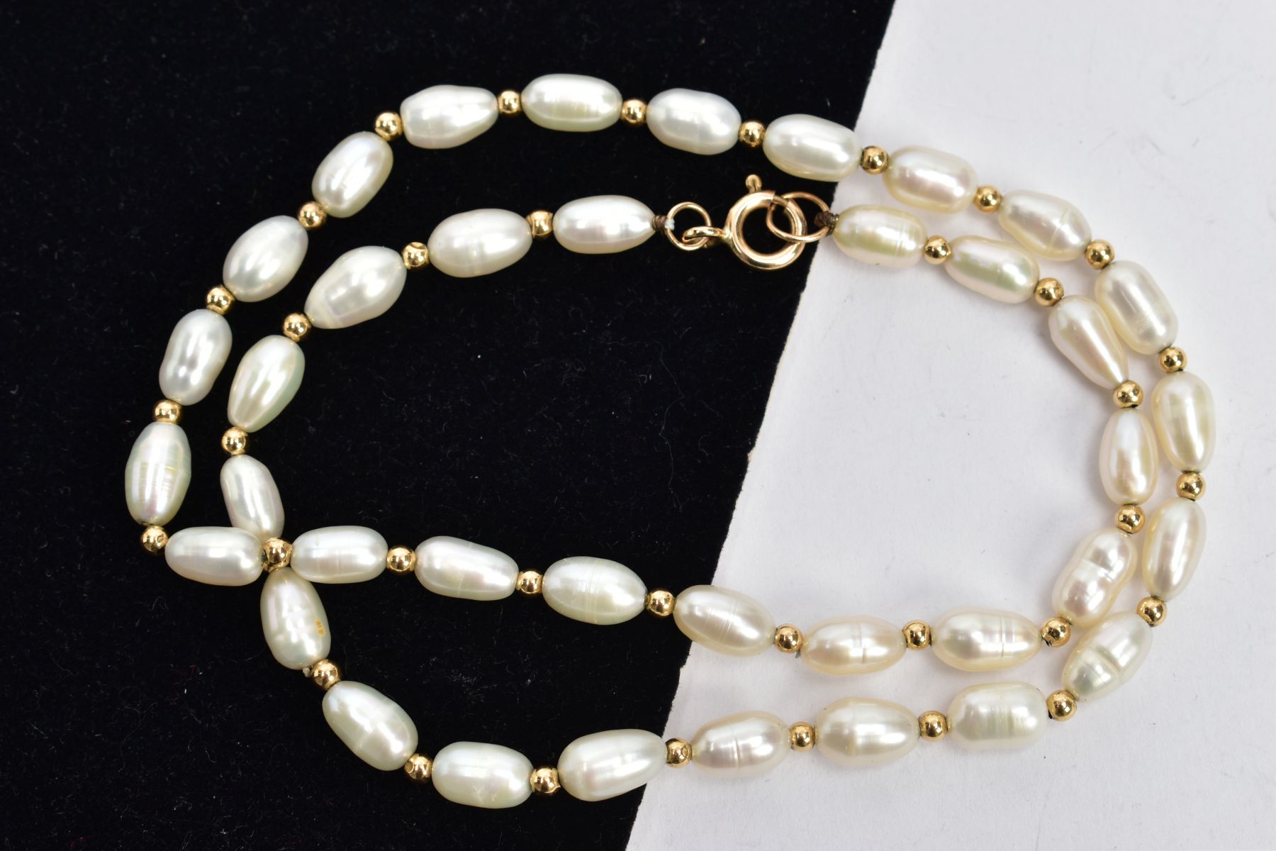 A CULTURED FRESHWATER PEARL NECKLACE, thirty-eight baroque fresh water pearls interspaced between