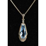 A PENDANT NECKLACE, the pendant of an art deco style set with a light blue fancy cut stone