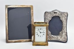 TWO SILVER PHOTO FRAMES AND A CARRIAGE CLOCK, the first frame featuring a floral design and an