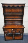 A TITCHMARSH AND GOODWIN STYLE OAK DRESSER, the top with double tier plate rack, over a base with an
