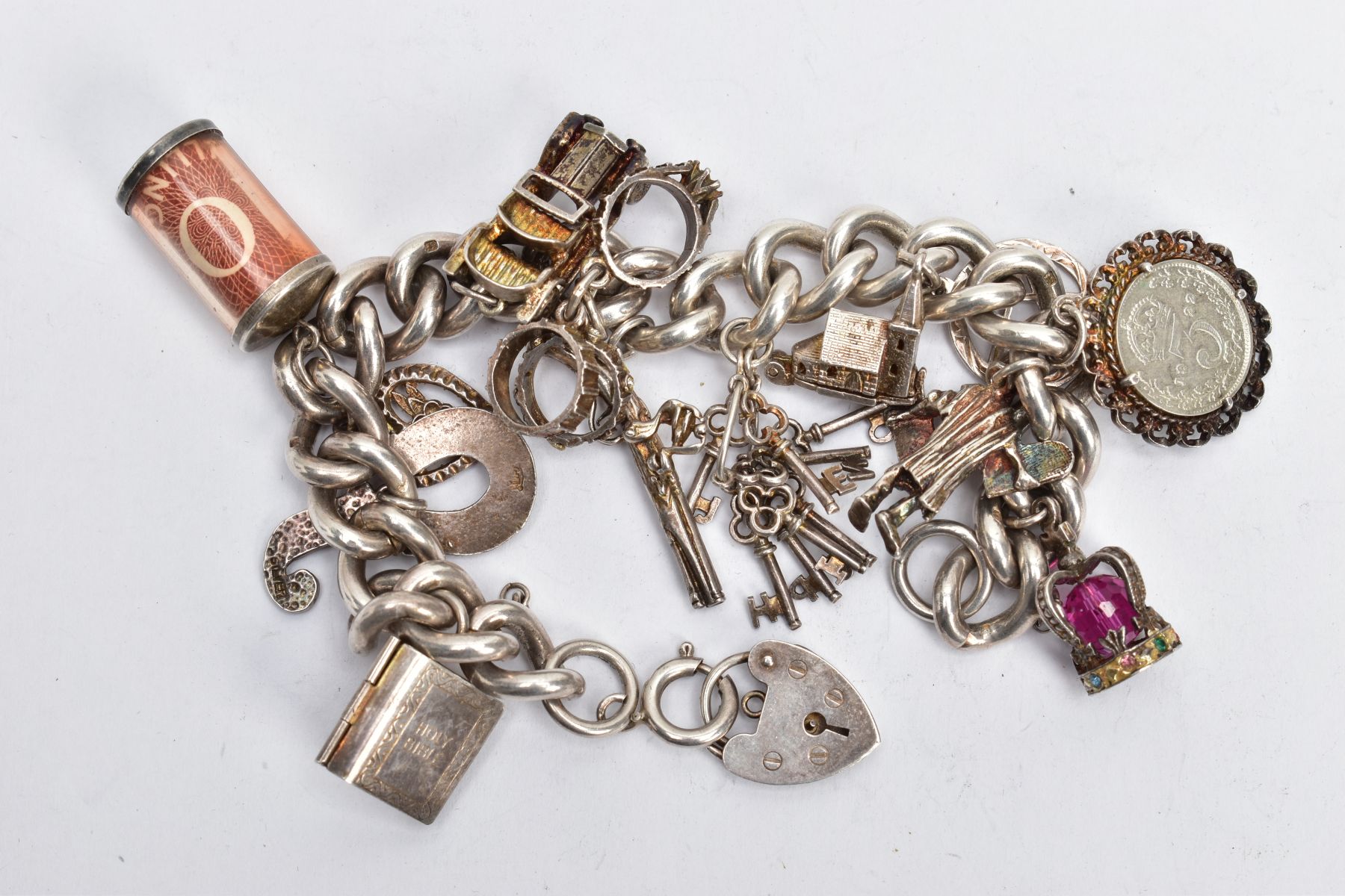 A SILVER CHARM BRACELET AND CHARMS, a thick curb link bracelet, fitted with spring clasp and a heart - Image 2 of 2