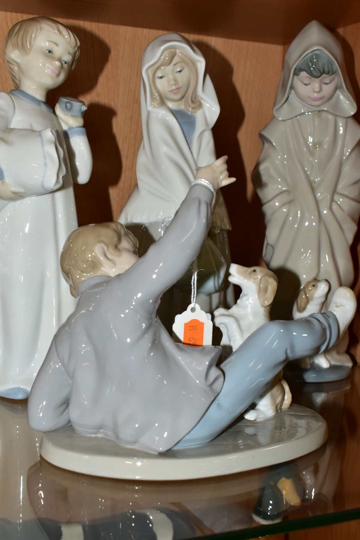 FOUR NAO PORCELAIN FIGURES OF CHILDREN, comprising boy lying down playing with a dog, possibly - Image 4 of 8